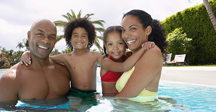 Happy family spending time in the swimming pool